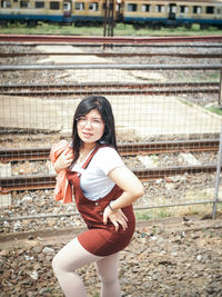 Portrait of a smiling young woman standing outdoors