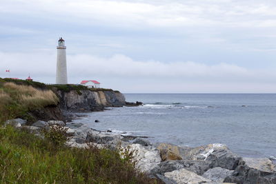 The cap-des-rosiers lighthouse in gaspé, quebec seen during a grey afternoon