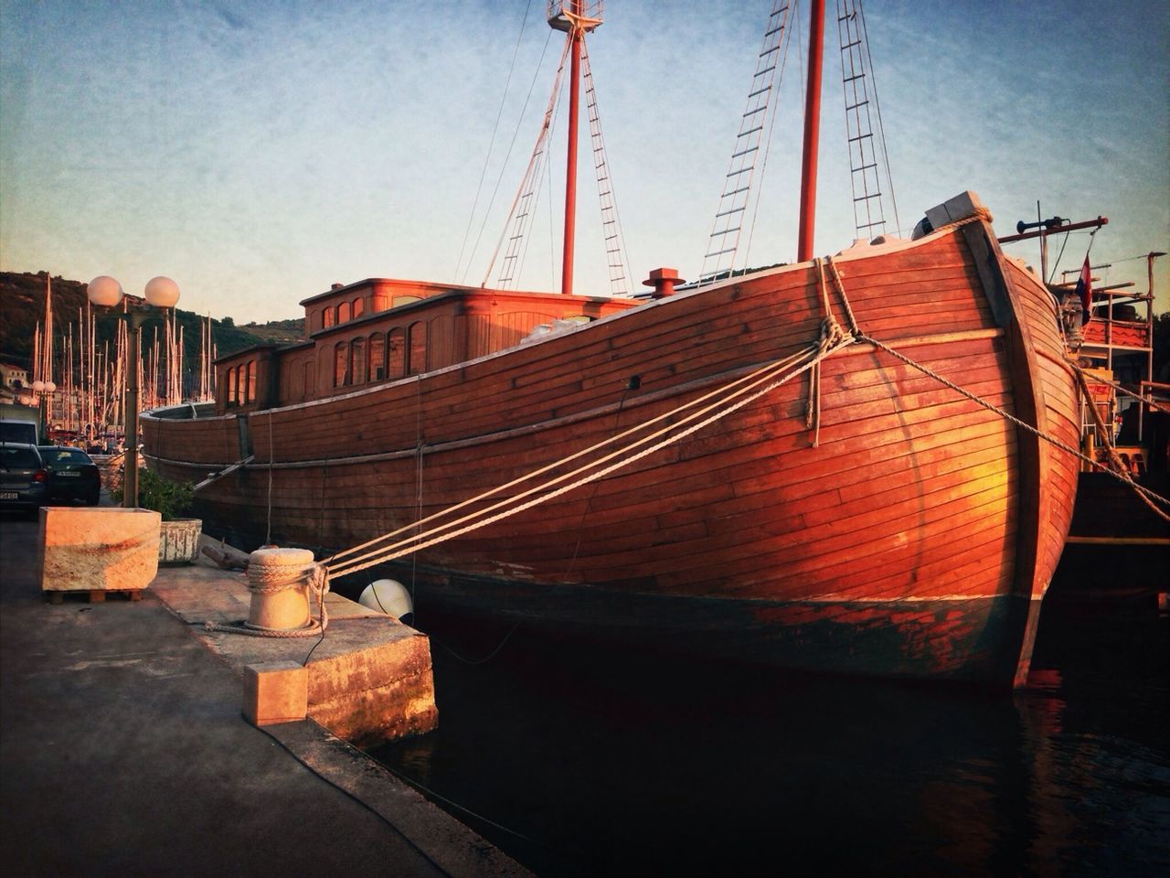 built structure, architecture, sunset, nautical vessel, sky, construction site, transportation, crane - construction machinery, boat, rope, orange color, outdoors, metal, moored, no people, sunlight, development, building exterior, water, harbor