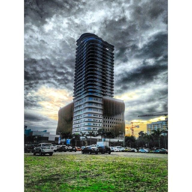 sky, building exterior, architecture, built structure, cloud - sky, transfer print, cloudy, auto post production filter, cloud, land vehicle, car, transportation, grass, city, overcast, outdoors, mode of transport, day, weather, abandoned