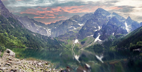 Wide angle shot of misty and rainy view of mountain landscape with dramatic sky in morskie oko