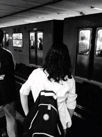 Rear view of two people sitting in train