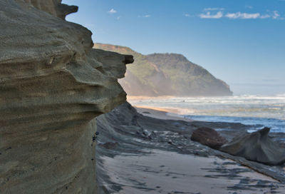 Close-up of rocks on beach against sky