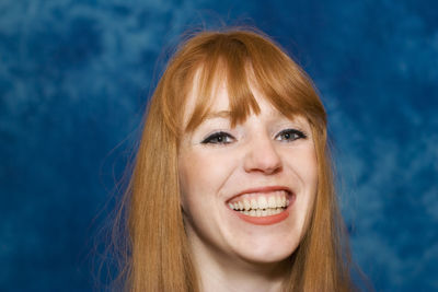 Close-up portrait of smiling young woman