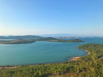 Scenic view of bay against clear blue sky