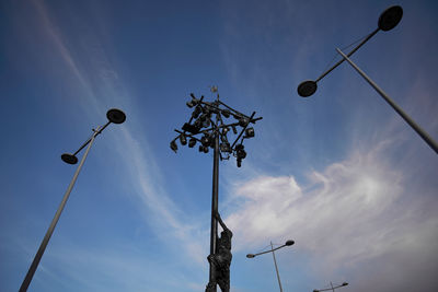 Low angle view of street lights against sky