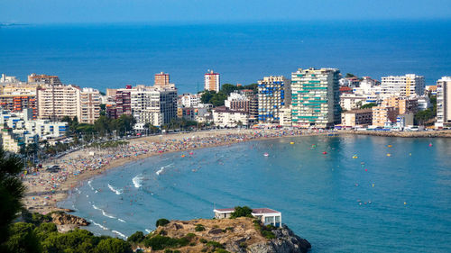 High angle view of sea and buildings against sky