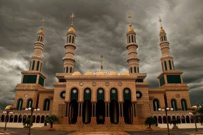 Low angle view of historical building against cloudy sky