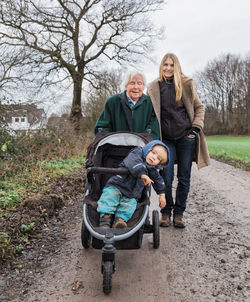 Portrait of happy family on footpath