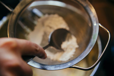 Close-up of person preparing food in bowl