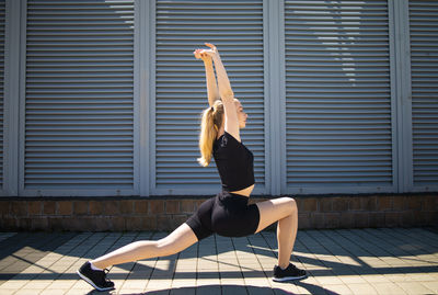 Woman workout, outdoor exercise in city.