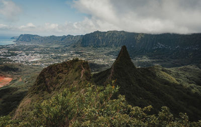 Scenic view of mountains against cloudy sky