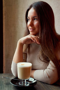 Woman with coffee cup on table