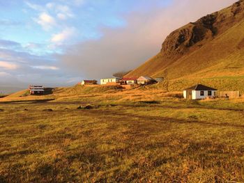 Houses on field against sky