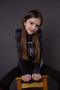 Portrait of smiling girl sitting on seat