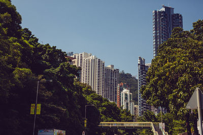 Modern buildings in city against clear sky