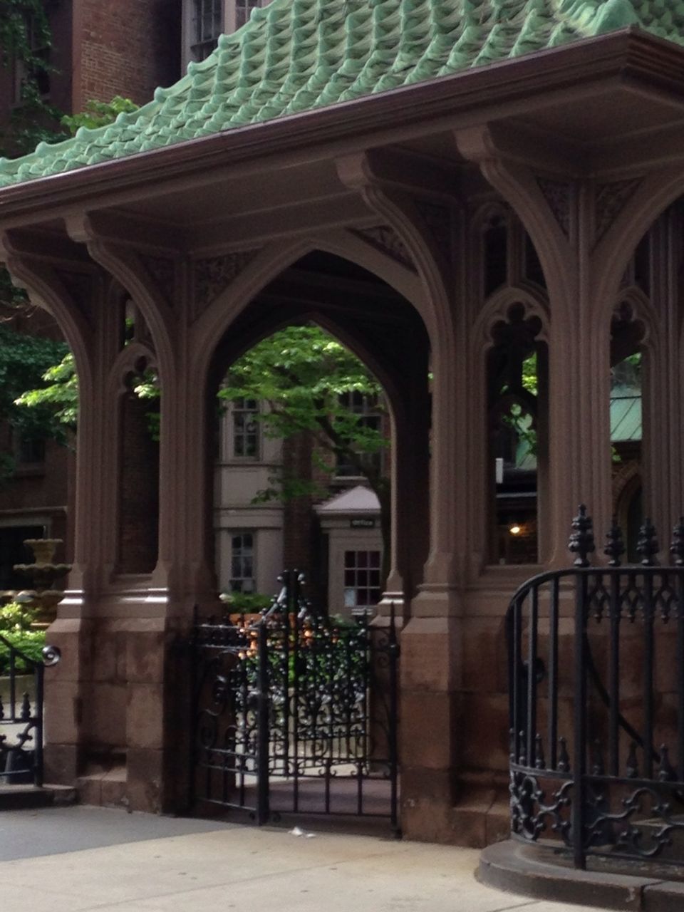 architecture, built structure, building exterior, arch, architectural column, tree, potted plant, entrance, place of worship, religion, window, sunlight, gate, day, spirituality, column, building, door, house, no people