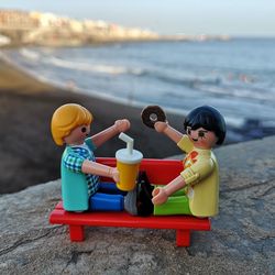 Boy sitting on toy at beach