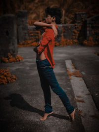 Full length of woman standing on footpath