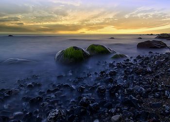 Scenic view of sea against sky at sunset