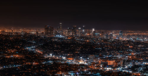 High angle view of illuminated buildings against sky at night