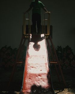Low angle view of woman standing against sky