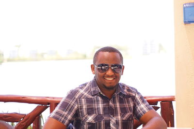 Portrait of smiling man sitting outdoors