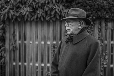 Man looking away while standing outdoors