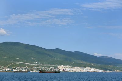 Scenic view of sea and mountains against sky