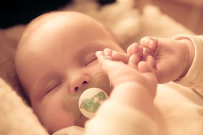 Close-up of baby holding hands