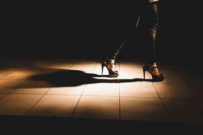 Low section of man standing on tiled floor