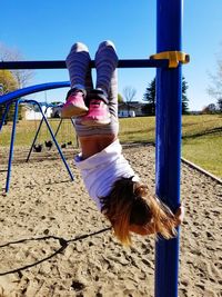 Playful girl playing on outdoor play equipment at playground