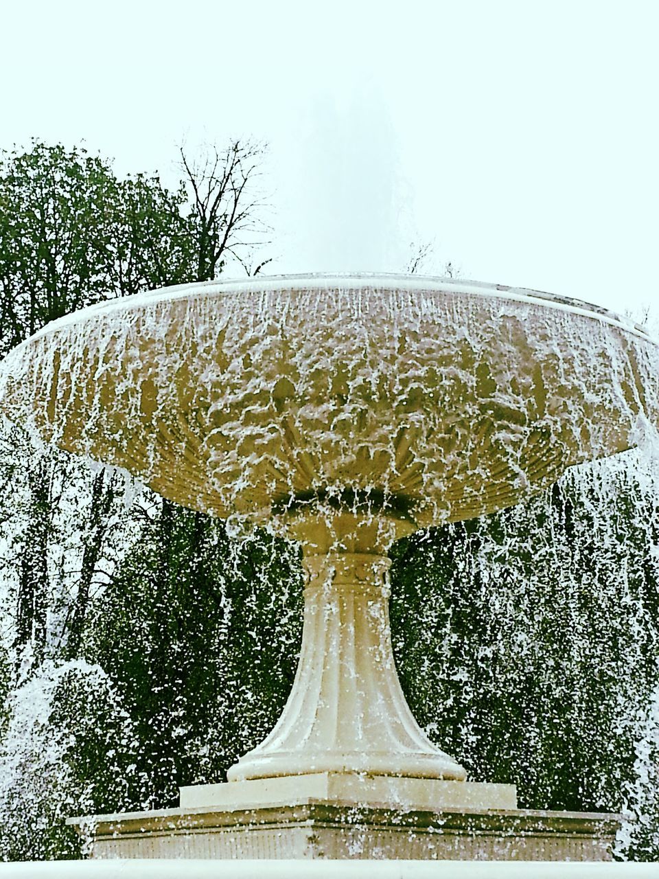 art and craft, art, clear sky, sculpture, creativity, fountain, statue, tree, human representation, famous place, religion, white color, design, low angle view, water, travel destinations, day, built structure, spirituality, sky