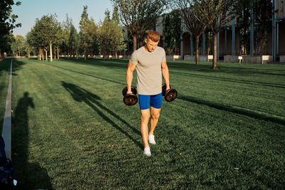 Full length of boy running on grass