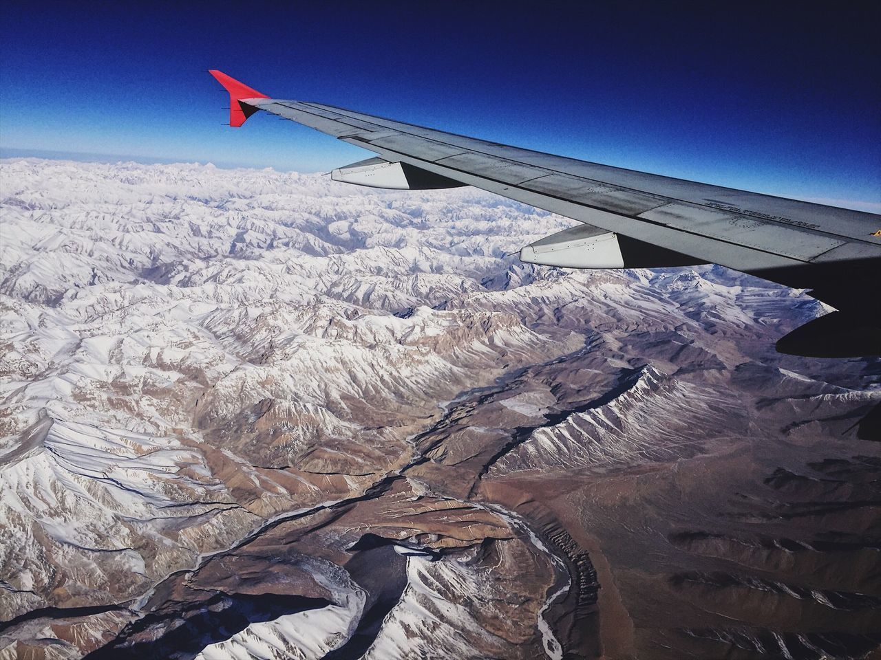 air vehicle, airplane, aircraft wing, transportation, flying, no people, sky, travel, mode of transportation, mountain, scenics - nature, beauty in nature, landscape, nature, environment, day, mid-air, physical geography, aerial view, tranquil scene, snowcapped mountain, formation