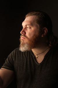 Portrait of senior man against black background