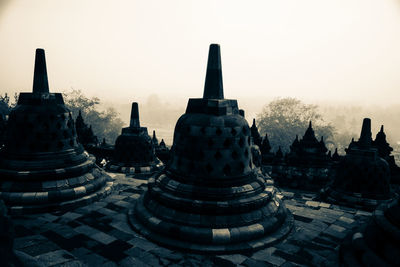 Stupas at temple against sky