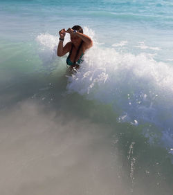 Full length of shirtless man in sea