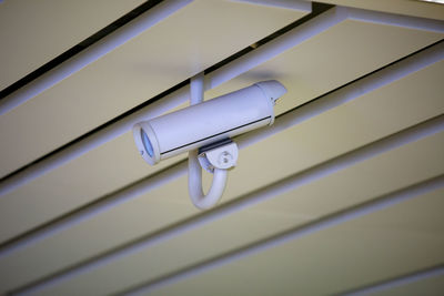 Low angle view of security camera on ceiling