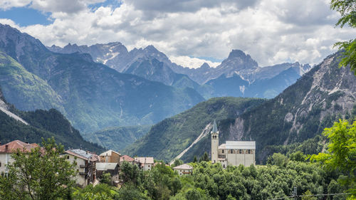 Houses and mountains against sky