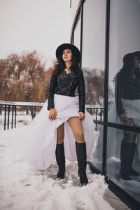Young woman standing on snow