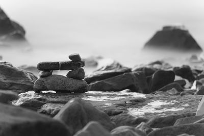 Close-up of rocks on beach against sky