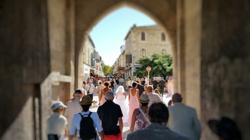 Tilt shift image of people walking in archway