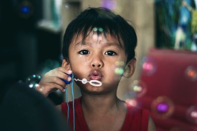 Portrait of cute boy holding camera