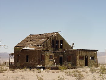 Abandoned building against clear sky