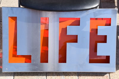 Close-up of text on orange wall