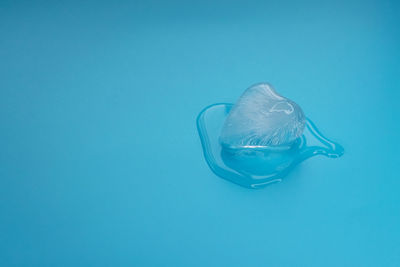 Close-up of drink in water against blue background