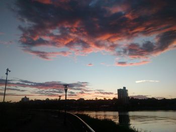 Bridge over city against sky during sunset