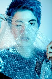 Portrait of woman holding bubble wrap