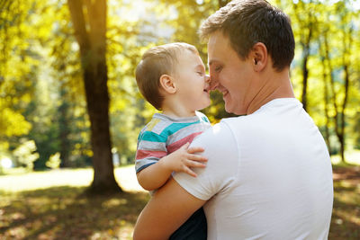 Dad plays with his little son in the park outdoors. family pastime. happy smiling people. 